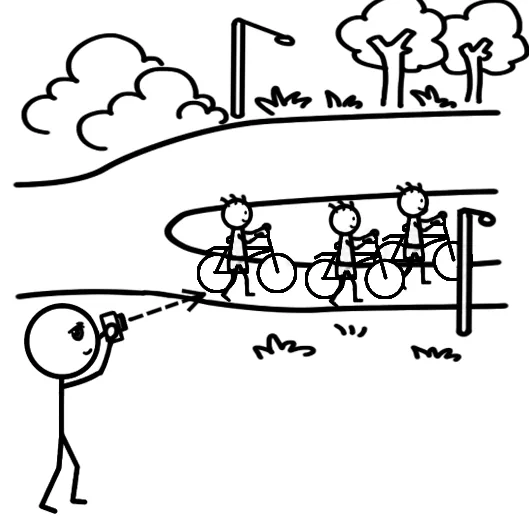 Boys pushing bicycles on a narrow path — one frame